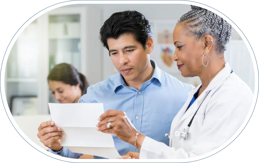 Female doctor wearing a white coat explaining billing disclosures to her male patient.