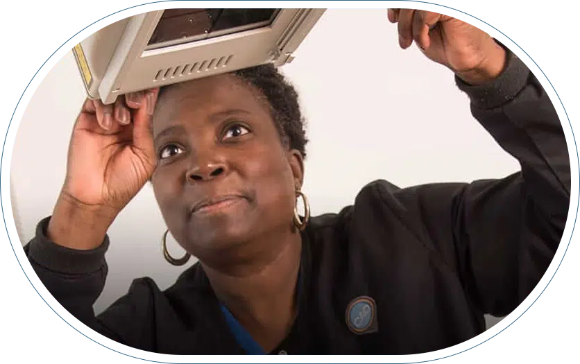 Medical professional handling MRI imaging equipment.