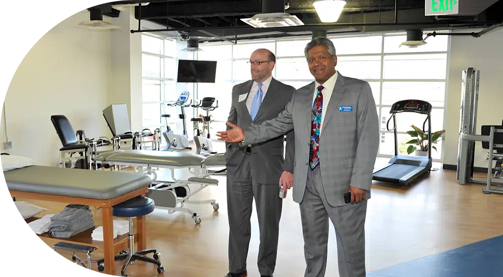 Doctor at CAO welcoming patients to their physical therapy appointment.