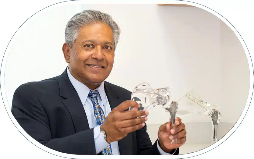 Orthopedic physician demonstrating the importance of nutrition for surgery recovery to a patient using a model of a hip.