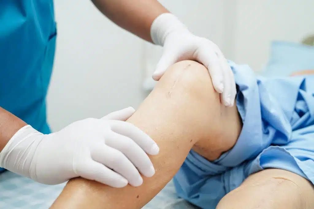 Image of patient with doctor after a knee replacement surgery.