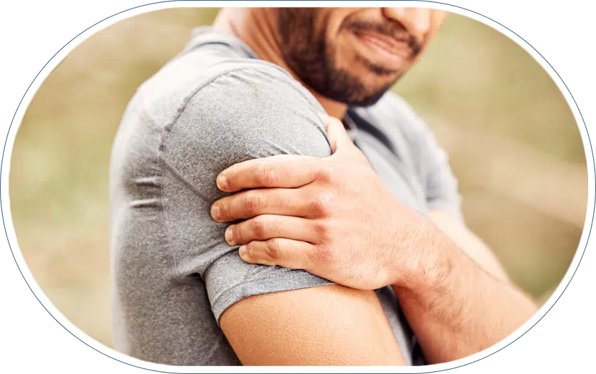 close up of a man with shoulder pain likely from shoulder impingement syndrome
