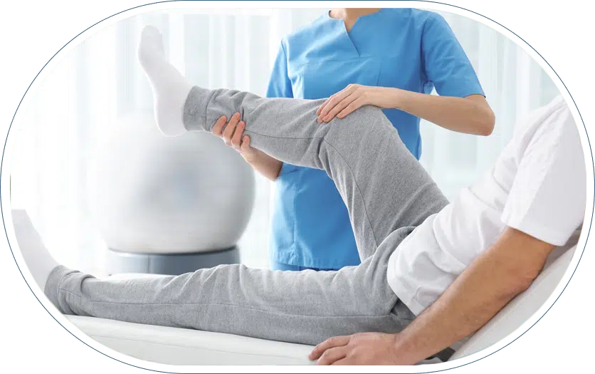 Physical therapist assisting patient with leg exercises during pre-surgery rehabilitation therapy session