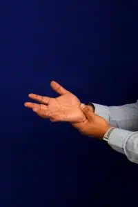 A man suffers from pain, numbness and tingling in the wrist, hand and fingers symptoms of Carpal Tunnel Syndrome.