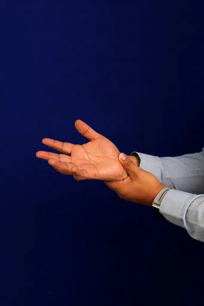 A man suffers from pain, numbness and tingling in the wrist, hand and fingers symptoms of Carpal Tunnel Syndrome.