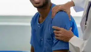 Image of an orthopedic surgeon specializing in shoulder care is with a patient.
